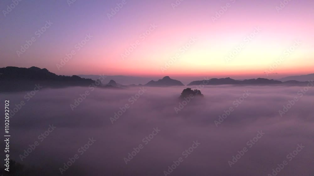 Drone flying over sea of mist and mist in forest-covered mountains at sunrise. Drone flying over sea of mist and mist in forest-covered mountains at sunrise.
