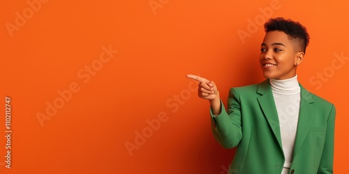A young non-binary person pointing confidently to the right at a blank space