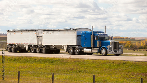 Heavy Cargo on the Road. A truck hauling freight along a highway. Taken in Alberta, Canada