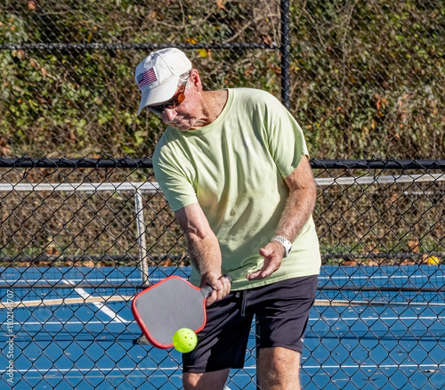 Senior man stays in shape by playing pickleball