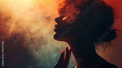 Silhouette of a woman in smoke with warm lighting