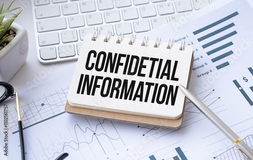 Top view of text confidential information with calculator, magnifying glass and pen on financial charts . Business, calculation, strategy, searching and tax concept. Top view. photo