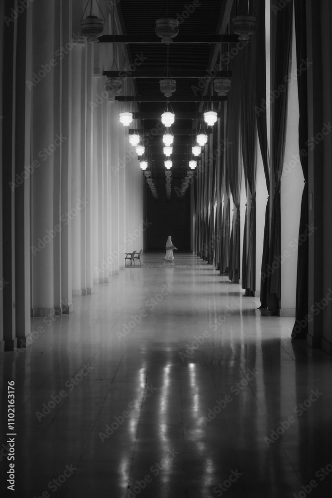 a woman passing in corridor a woman passing in corridor