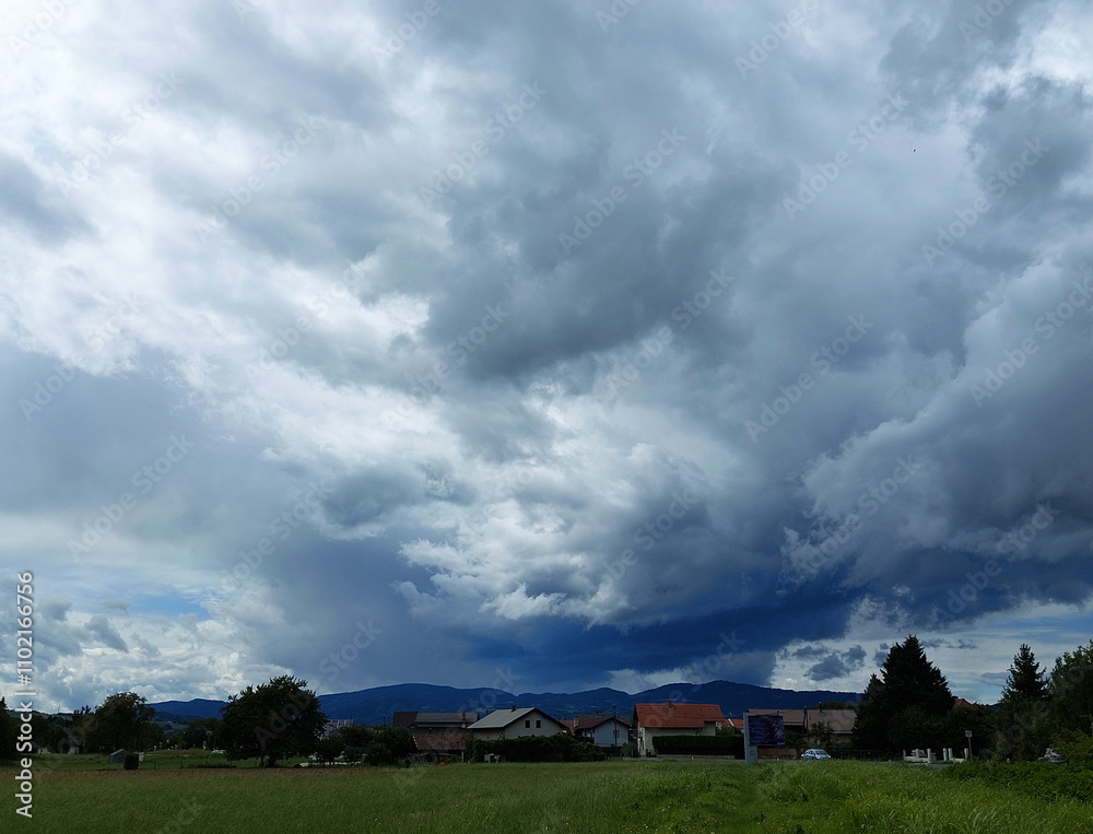 dark gray clouds over houses. Slovenia. Sky before storm