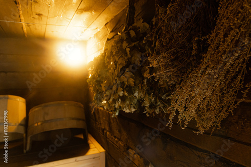 Slika na platnu A dimly lit Russian bathhouse with wooden walls and a single light bulb illuminating the space
