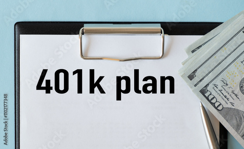 Notebook with word 401k plan on financial background photo