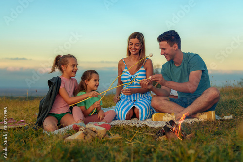 Принти на полотні A happy family makes marshmallows by the fire, blended family bounding together