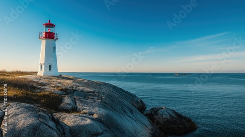 A vibrant red and white lighthouse on rocky shore overlooking calm waters at sunrise