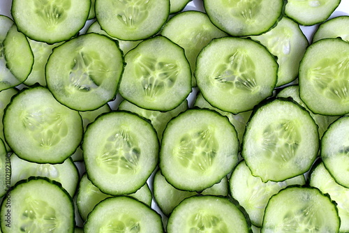 Texture of sliced cucumbers stacked on top of each other.	