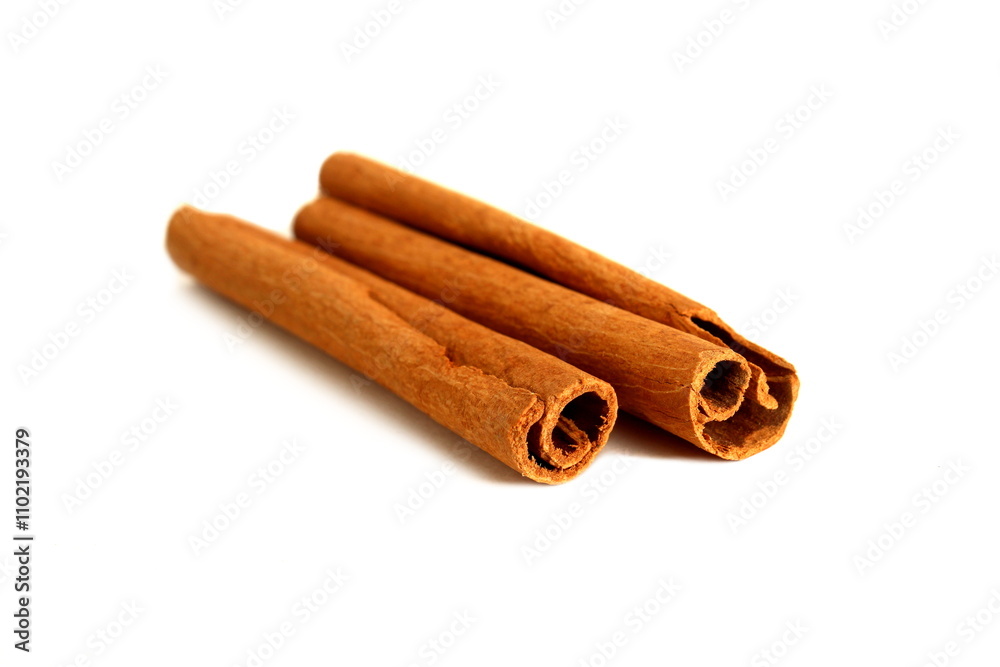 On a white background lie spices, two cinnamon sticks. On a white background lie spices, two cinnamon sticks.