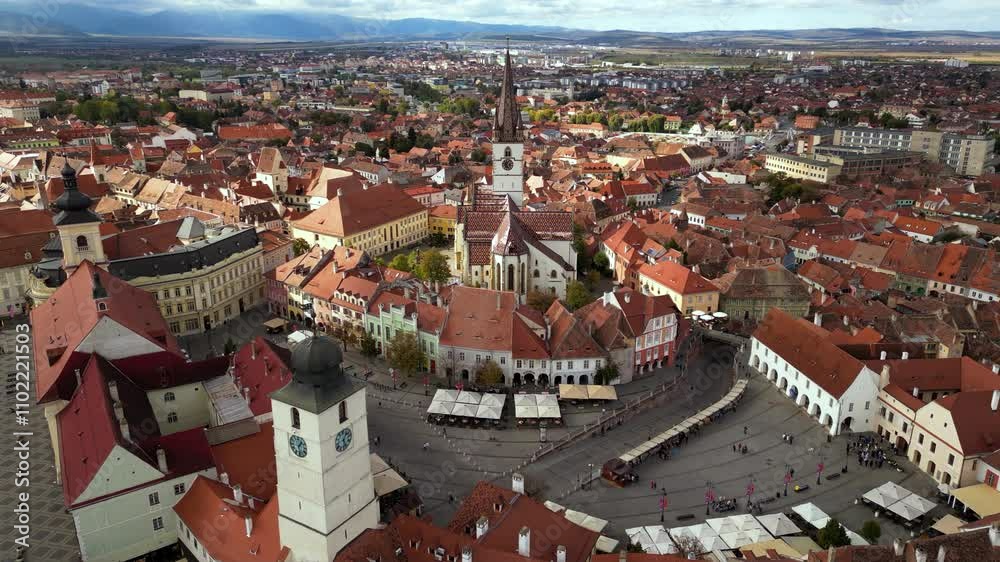 Aerial footage of the city of Sibiu in Romania. The old town center of Hermannstadt in Transylvania seen from above on a sunny day. Romanian cityscape in modern times. Establishing shot. Touristic.
