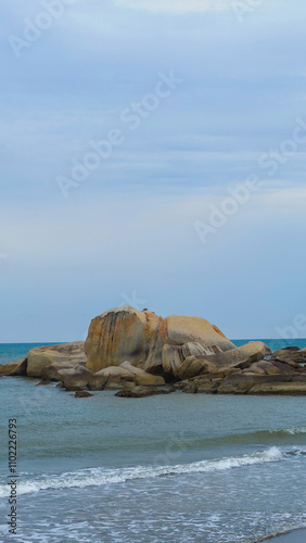 Vast Blue Ocean Sea Surrounding Big Brown Orange Boulder Rocks