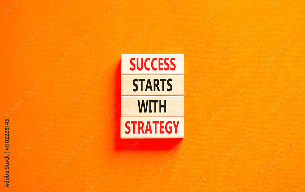 Success starts with strategy symbol. Concept words Success starts with strategy on beautiful wooden blocks. Beautiful orange background. Business and success starts with strategy concept. Copy space. Success starts with strategy symbol. Concept words Success starts with strategy on beautiful wooden blocks. Beautiful orange background. Business and success starts with strategy concept. Copy space.