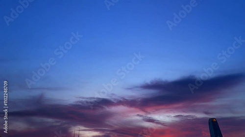 Vibrant Sunset Over City Skyline with Dramatic Cloud Patterns