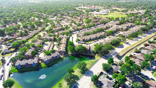 Apartment complex, residential neighborhood in lakeside community in Coppell suburbs Dallas, Texas, tree lined residential street, row of single-family houses, fast growing housing market, aerial photo