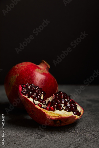 Fresh pomegranate on dark background for healthy food concept photo