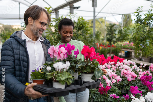 Smiling in a Vibrant Garden Store Filled with Flowers photo