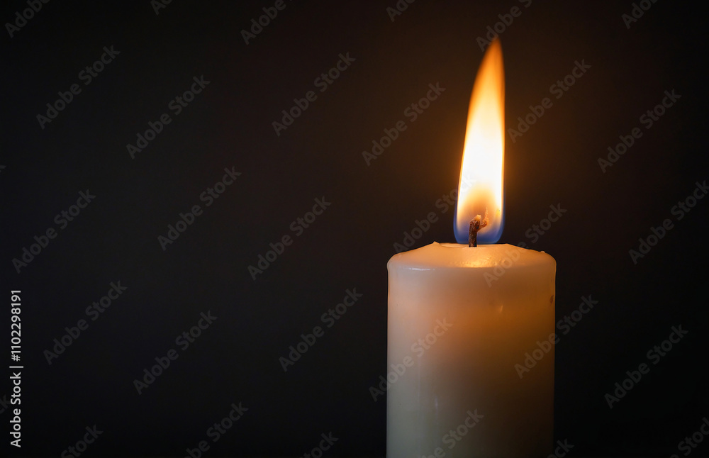 soft-focus shot of a candle flame in one corner of a dark, neutral background soft-focus shot of a candle flame in one corner of a dark, neutral background