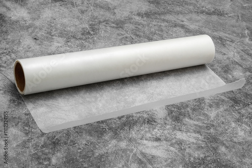 Roll of wax paper on gray background