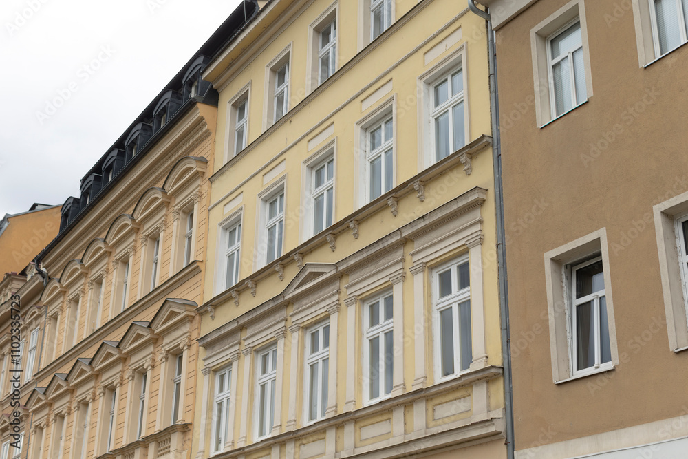 A large, multistory building featuring numerous windows throughout its design, creating an inviting facade and allowing ample light inside A large, multistory building featuring numerous windows throughout its design, creating an inviting facade and allowing ample light inside