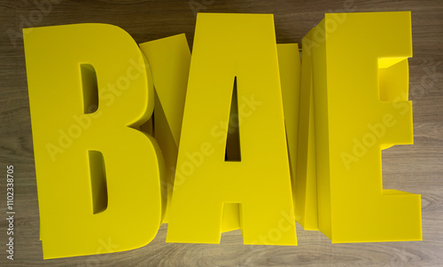 Three-dimensional letters made of plastic for signage. The letters of the logo are yellow. Production of outdoor advertising. photo