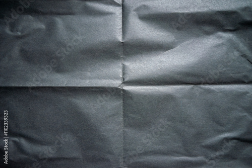 A photo of the texture of black crumpled paper.Black paper for text. High-resolution dark background.