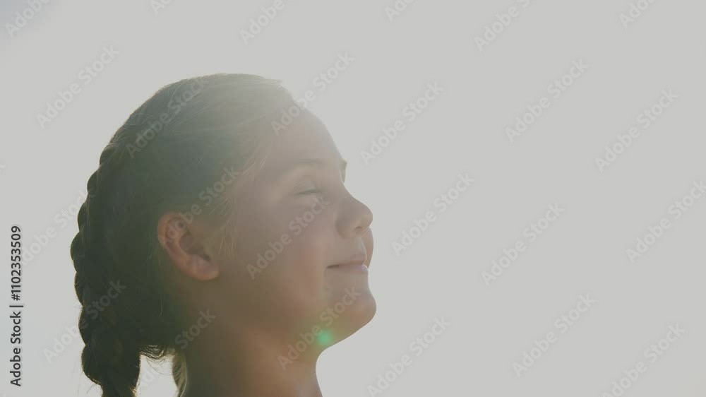 Child girl dreams with her eyes closed. The concept of child youth dreams childhood. A girl smiles at the sun in her dreams. A girl with closed lifestyle eyes dreams of the sun. Child girl dreams with her eyes closed. The concept of child youth dreams childhood. A girl smiles at the sun in her dreams. A girl with closed lifestyle eyes dreams of the sun.