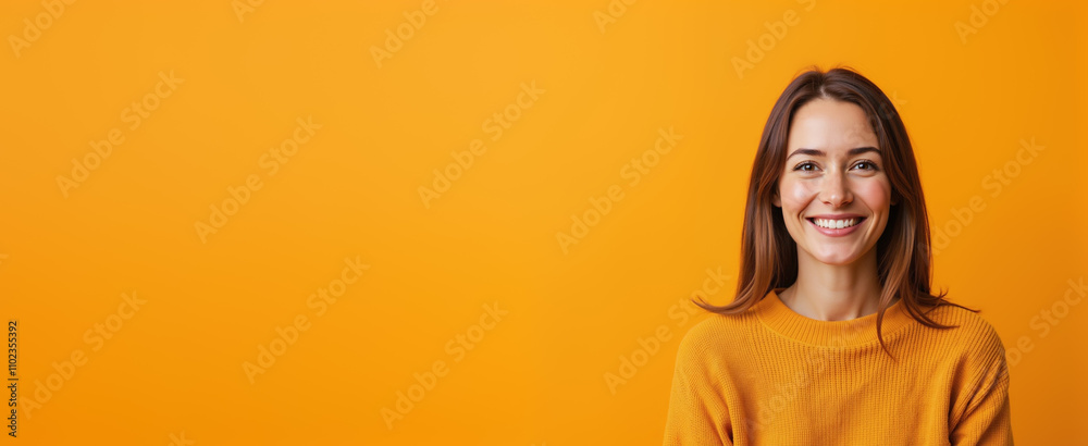 Cheerful woman smiling brightly against vibrant orange background with copy space Cheerful woman smiling brightly against vibrant orange background with copy space