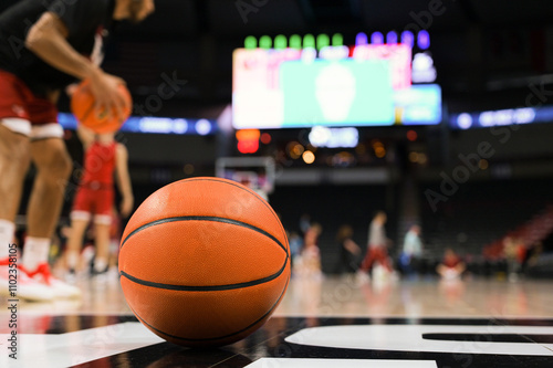 Bilde på lerret Game Time Focus: Orange Basketball on Court with Blurred LED Scoreboard