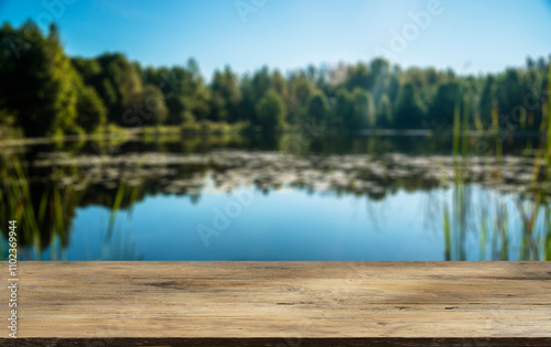 Fototapeta Naklejka Na Ścianę i Meble -  Wooden table with forest lake and nature background. Product display background.