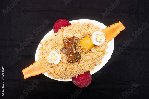 mutton kacchi biryani with boiled egg served in tray dish isolated on wooden table side view of bangladeshi food photo