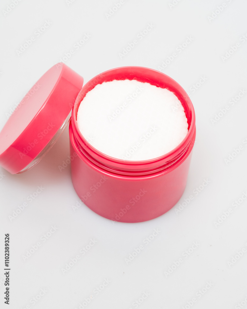 Cosmetic cream or white powder in pink container isolated on white background Cosmetic cream or white powder in pink container isolated on white background