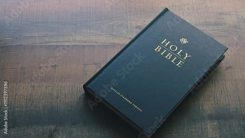 Still Close-Up Shot of Holy Bible ESV on top of wooden table soft lighting by the window and color graded