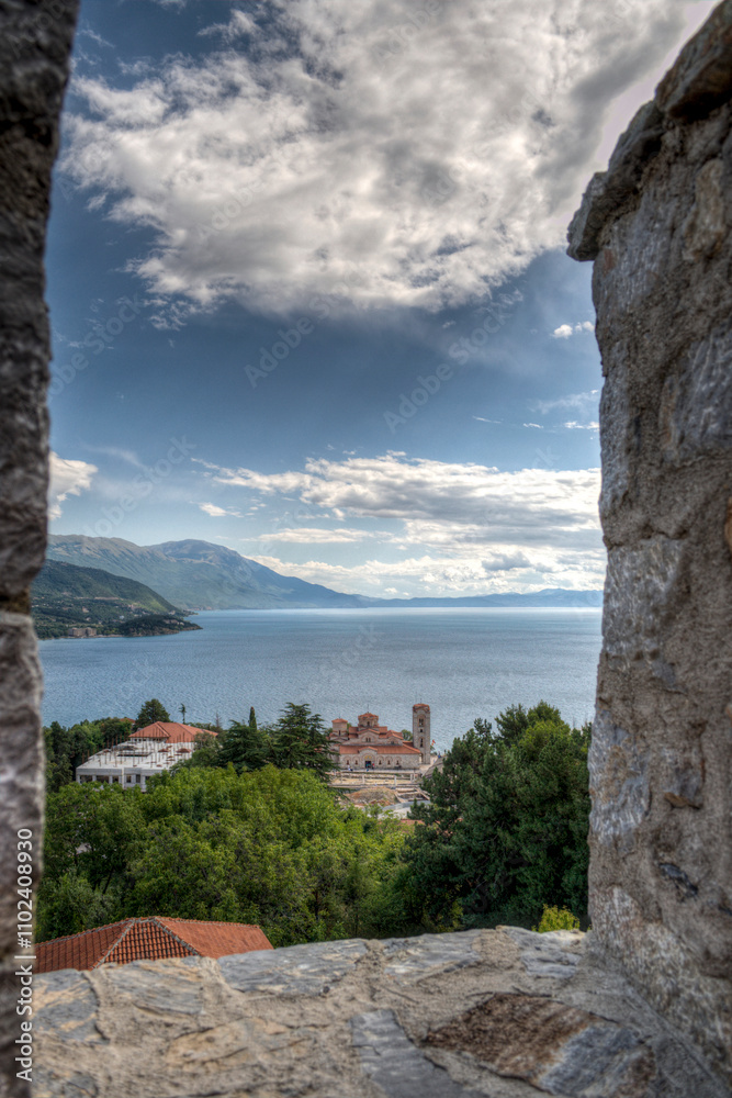 Naklejka premium Castle walls, view of Samuil's Fortress, Unesco World Heritage Site, on Lake Ohrid, Ohrid town. View from watchtower of famous old fortress ruins of king Samuel. Clouds over the Lake and blue water.