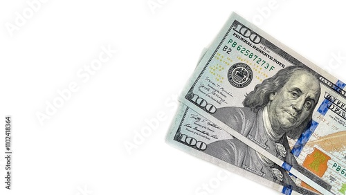 Close-up of two 100 US dollar bills angled on a white background, providing ample copy space. Ideal for use in financial advertisements, banking promotions, or educational content about currency and f photo