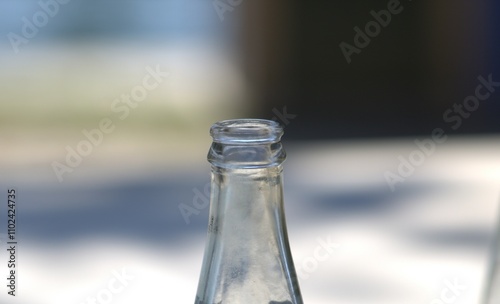top opening of glass bottle up close photo