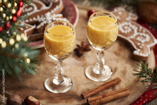 Two shot glasses of Eiecognac with spices and gingerbread Christmas cookies photo