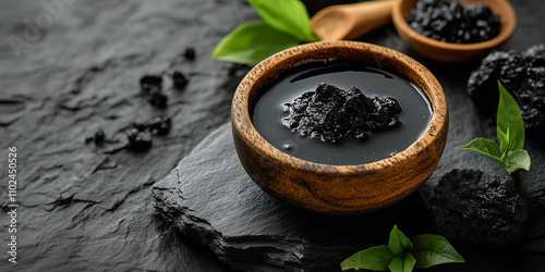 shilajit mineral-rich resin in wooden bowl, ayurveda health supplement for testosterone boost and immune boost