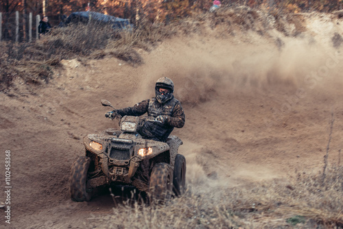 Quad bike. Cross-country quad bike, extreme sports. ATV Bike speed. Man riding ATV vehicle on off road track. People aoutdoor sport activities theme.