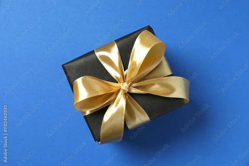 Beautiful gift box tied with bow on color background Beautiful gift box tied with bow on color background