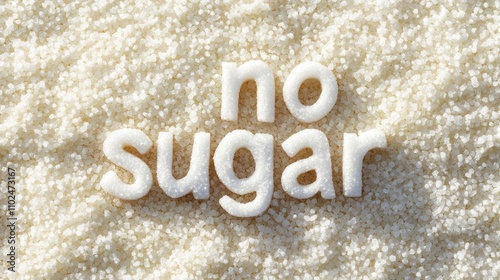 White letters spelling no sugar rest on a bed of granulated white sugar crystals, symbolizing a sugar free or low sugar lifestyle choice photo