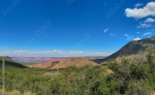 Mesa view red rocks blue sky with clouds Moab Utah