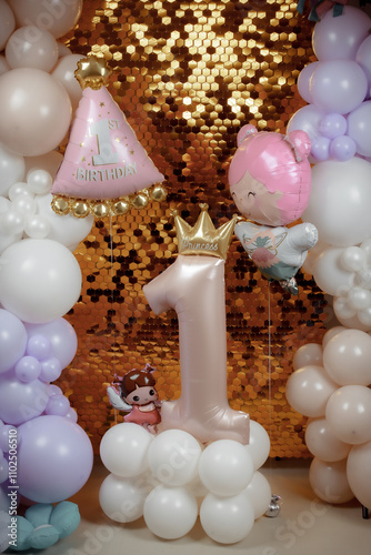 Shiny photo zone with golden mosaic and colored balloons. Aerodesign of children's parties. Theme - first year of the child. Large inflatable number one with the inscription princess. photo