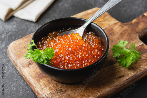Red salmon caviar with parsley in a bowl