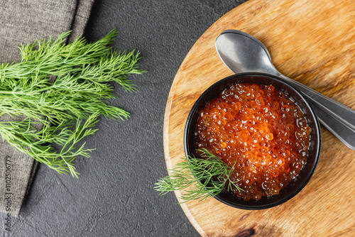 Red salmon caviar with fresh dill in a bowl