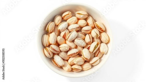 A close-up of pistachios arranged artfully in a bowl with a sprinkle of powdered sugar on a white background, bowl, white background