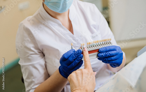 Dentist consulting patient on tooth shade selection for a natural and perfect smile restoration photo