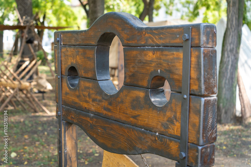 Canvas Print Medieval wooden pillory in a park