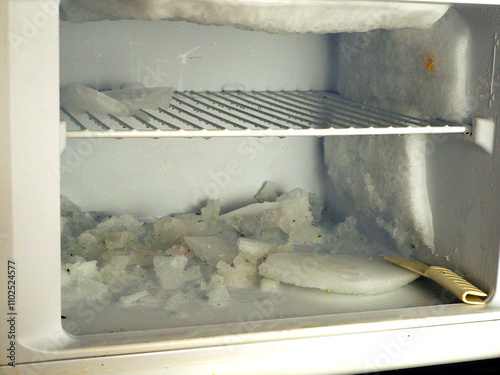 Defrosting Freezer Compartment with Ice Build-Up and Melting Frost in Home Refrigerator