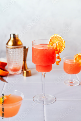 Blood Orange Margaritas on a tiled table with grey background photo